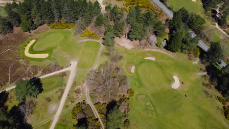Aerial-top-view-of-green-grass-and-trees-on-a-golf-field