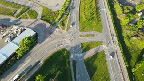 Bus-and-cars-moving-along-the-complicated-road-intersection-in-Gdansk-Poland,-top-down-view-aerial