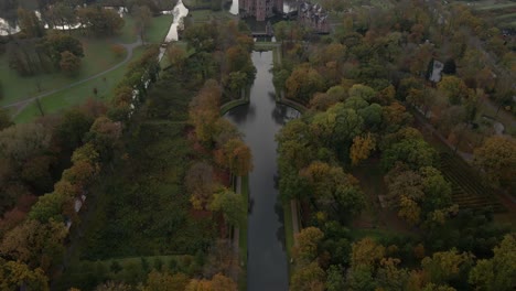 Above-classic-woodland-estate-in-Holland-with-grand-castle-at-end-of-pond