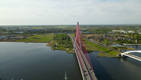 Third-Millennium-John-Paul-II-bridge-in-Gdansk,-Poland,-aerial-side-sliding-from-high-point,-Cityscape-on-background
