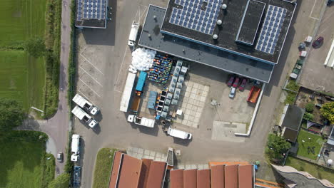 Top-down-aerial-of-garbage-truck-being-emptied-on-recycling-station