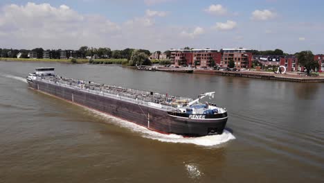 Aerial-Tracking-View-Of-Inland-Tanker-Renee-Along-River-Noord