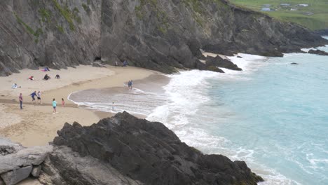 Tourists-Enjoying-At-Coumeenoole-Beach,-Republic-of-Ireland---wide-shot