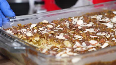 Getting-A-Portion-Of-Freshly-Baked-Banana-Caramel-Cake-Topped-With-Sliced-Almonds