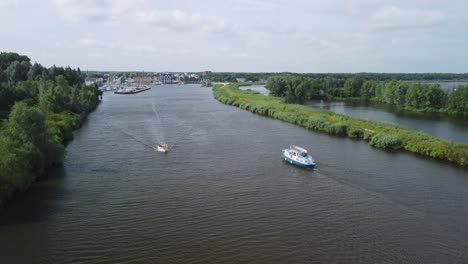 Aerial-view-of-two-small-boats-passing-each-other-at-the-entrance-of-the-harbor