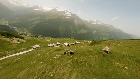 Aerial-View-Of-A-Racer-Biking-In-Val-d'Hérens-Alpine-Valley-During-Raid-Evolènard-2021-Race-In-Valais,-Switzerland