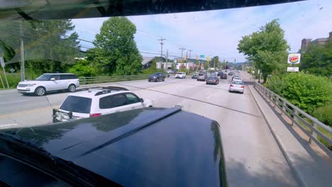 SEMI-TRUCK-IN-BUSY-TRAFFIC,-POINT-OF-VIEW-THROUGH-TRUCK-WINDSHIELD-AT-RUSH-HOUR