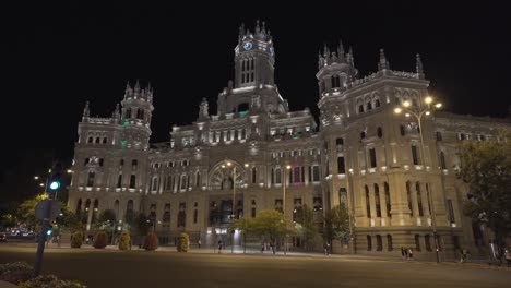People-Walk-In-Front-Of-Cybele-Palace-At-Night-In-Madrid,-Spain