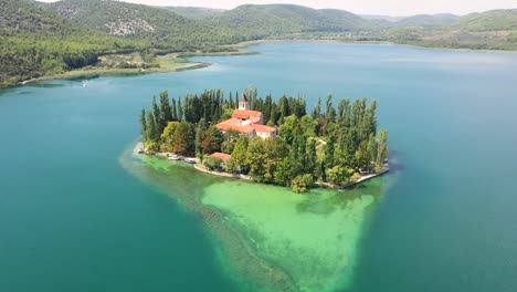 Aerial-shot-of-Visovac-Monastery-near-mountain---Krka,-Croatia