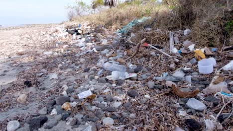 Heaps-of-plastic-bottles-and-other-rubbish-washed-up-on-the-beach-from-the-ocean-on-a-tropical-island