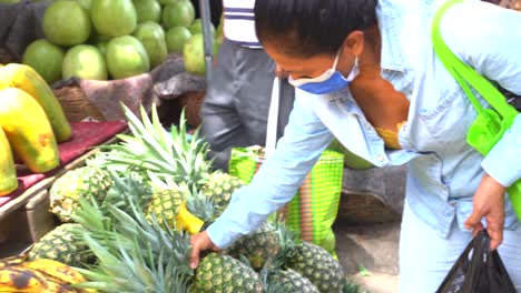 Hispanic-woman-buying-fruit-in-latin-america