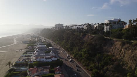 Aerial-shot-of-US-1-traffic,-hotels-and-apartment-buildings-on-the-California-coast