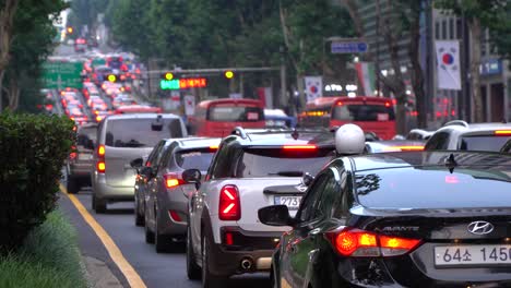 Line-of-Cars-Stoped-Stuck-in-Traffic-Jam-Gangnam-District,-Busy-Street-Road-Traffic-on-Sunset-Seoul-South-Korea---editorial-2021,-28th-July,-Korean-flags-along-the-road