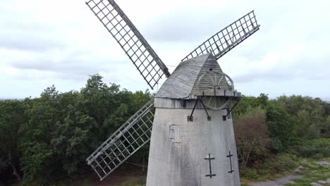 Bidston-hill-disused-rural-flour-mill-restored-traditional-wooden-sail-windmill-Birkenhead-aerial-view-closeup-orbiting-right