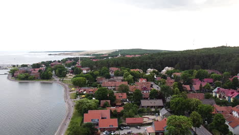 Lithuanian-resort-Nida-town-with-magical-red-rooftops,-aerial-drone-view