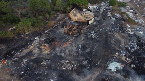 Aerial-View-Of-Debris-After-Fire-On-An-Old-Factory---drone-orbit