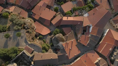 Aerial-rising-vertigo-over-roofs-at-Monsanto-village,-Portugal