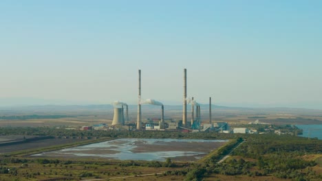coal-fired-electricity-power-plant-with-high-chimneys-and-smoke,-aerial