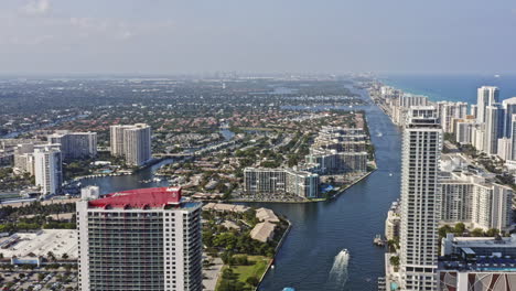 Hallandale-Beach-Florida-Aerial-v6-establishing-tracking-shot-overlooking-at-hollywood-lakes-neighborhood-with-intracoastal-waterways-as-leading-line-reveals-beachfront-condo-towers---March-2021
