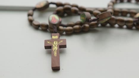 Close-Up-Tilt-Down-and-Pan-Left-of-Wooden-Rosary-Beads