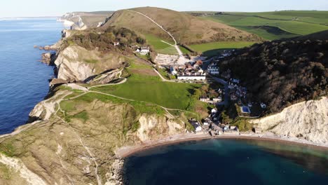 Aerial-backwards-shot-showing-Lulworth-Cove-looking-towards-Portland-in-the-distance