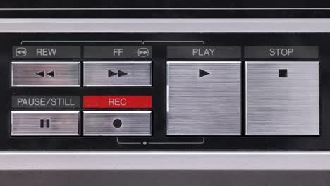 Extreme-close-up-of-buttons-on-an-old-antique-or-vintage-VCR-Pushing-the-pause-button