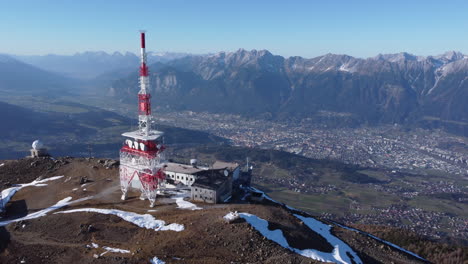 Aerial-over-Austrian-Innsbruck,-Patscherkofel-mountain-range-and-tower