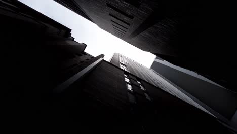 Person-Looking-Up-From-The-Alleyway-Between-City-Skylines-At-Daytime-In-Sydney,-New-South-Wales,-Australia