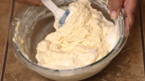 Stirring-thick-lemon-cake-batter-by-hand-in-a-mixing-bowl-before-baking