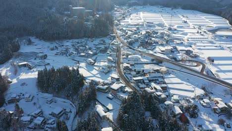Yamanouchi-covered-in-snow,-sun-rising-over-the-Nagano-Landscape,-Japan