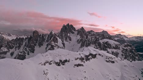 Slider-drone-shot-of-Candini-Group-Italian-dolomites-in-winter-beautiful-pink-sunset
