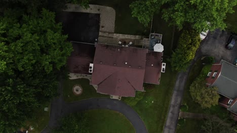 Aerial-Top-Down-Footage-Rising-Up-and-Turning-Over-a-Large-House-in-a-Luxury-Neighborhood