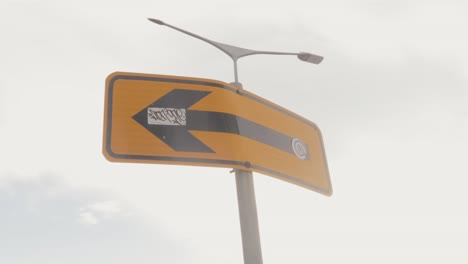 Pan-view-from-left-to-right-of-a-Direction-road-signage-put-up-by-the-police-indicating-left-movement-of-traffic-from-the-point-on-a-sunny-day
