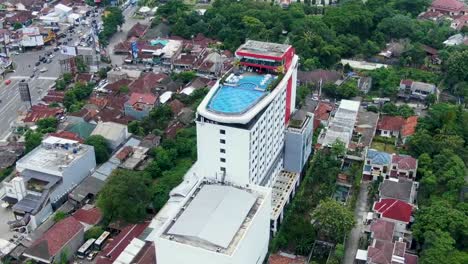 Aerial-pan-of-Indoluxe-Hotel-with-rooftop-pool,-Yogyakarta,-Indonesia