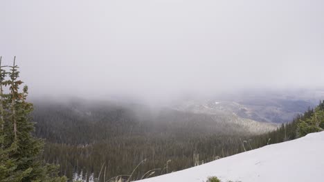 Timelapse-of-a-winter-storm-passing-over-a-large-forest-valley