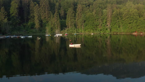 Local-Fisherman-In-Wooden-Boat-At-Lake-Bohinj-On-Sunny-Morning-In-Slovenia