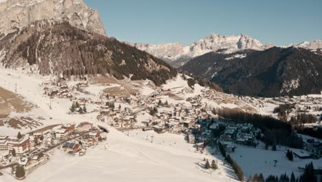 Drone-shot-over-picturesque-chalets-in-snowy-mountains