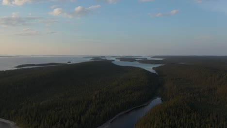 Drone-shot-of-wild-nature-lake-and-forest-at-sunset