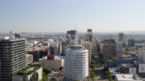 A-slow-aerial-pull-in-on-the-Capitol-Records-building-with-downtown-Hollywood-in-the-background