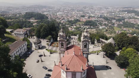 Aerial-view-from-drone-flying-over-Sanctuary-of-Bom-Jesus-do-Monte-in-Braga-and-valley-in-background
