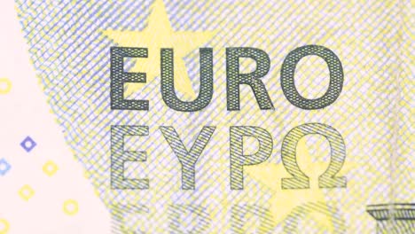 five-euro-bill-surface-detail-of-printed-letters-rotating,-macro-shot