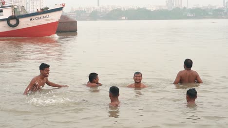 Slo-mo-video-of-Unidentified-pilgrims-taking-ritual-bath-in-the-river-Ganga-in-early-morning-in-Kolkata
