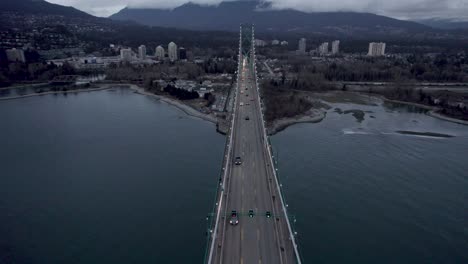 Amazing-flight-over-Lions-Gate-Bridge-with-mountain-in-background,-Vancouver-in-Canada