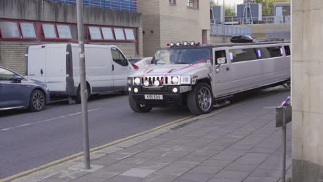 Asthetic-white-limousine-in-ribbon-for-a-groom-moving-on-the-street-of-London