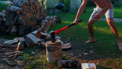 Strong-Man-Chopping-Wood-Using-An-Axe-In-The-Backyard-At-Summer