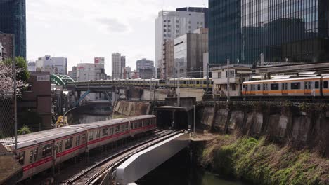 Multiple-Tokyo-train-passing-each-other-at-Ochanomizu-Station,-Early-Morning