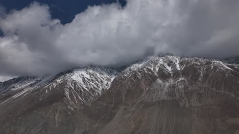 Ominous-Clouds-Above-Peaks-Of-Snow-Covered-Mountains-In-Hunza,-Pakistan