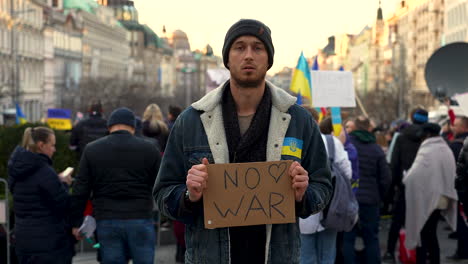Activist-with-protest-sign-against-war-in-Ukraine,-Prague,-slow-motion