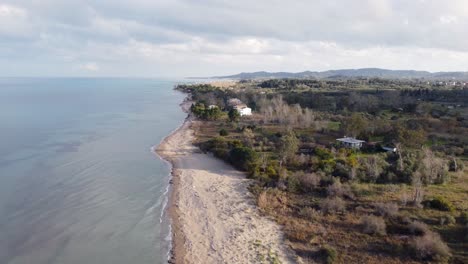 Dramatic-aerial-view-flight-fly-backwards-drone-footage-of-golden-sand-Bouka-Beach-at-Corfu