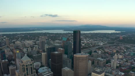 Wide-panning-aerial-shot-of-Seattle's-downtown-buildings-with-Capitol-Hill-and-Lake-Washington-in-the-background